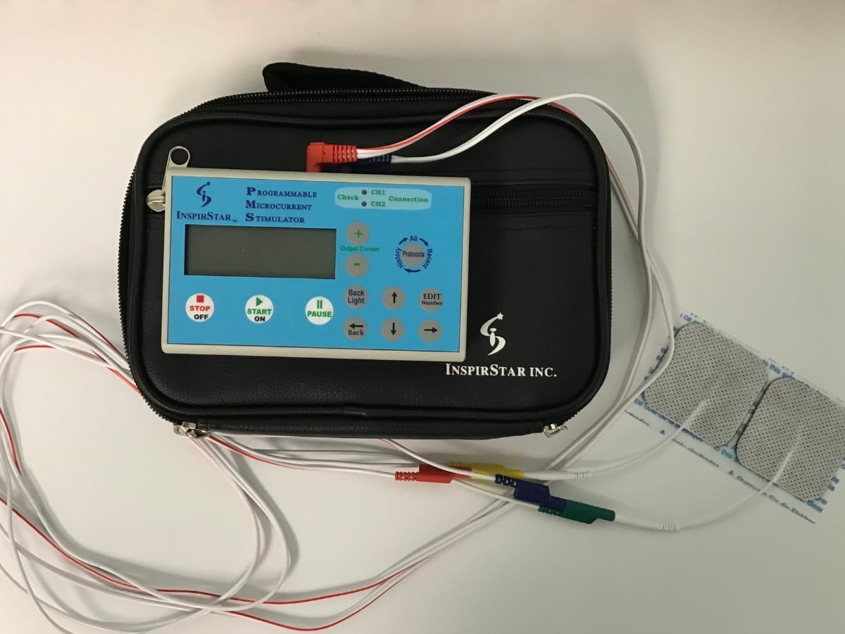 A Frequency Specific Microcurrent (FSM) device with gel pads attached.