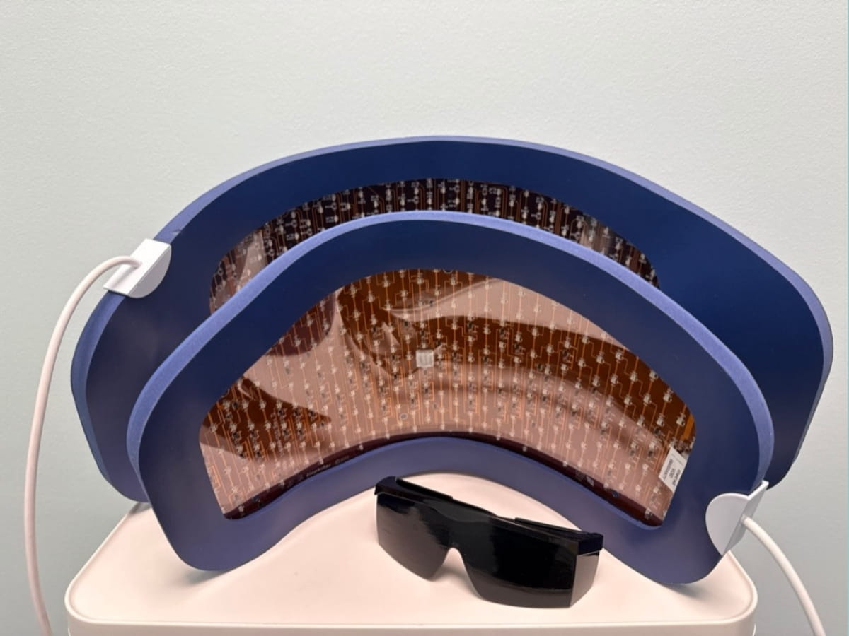 Two different sizes of Celluma LED Light Therapy panels with eye protection glasses.