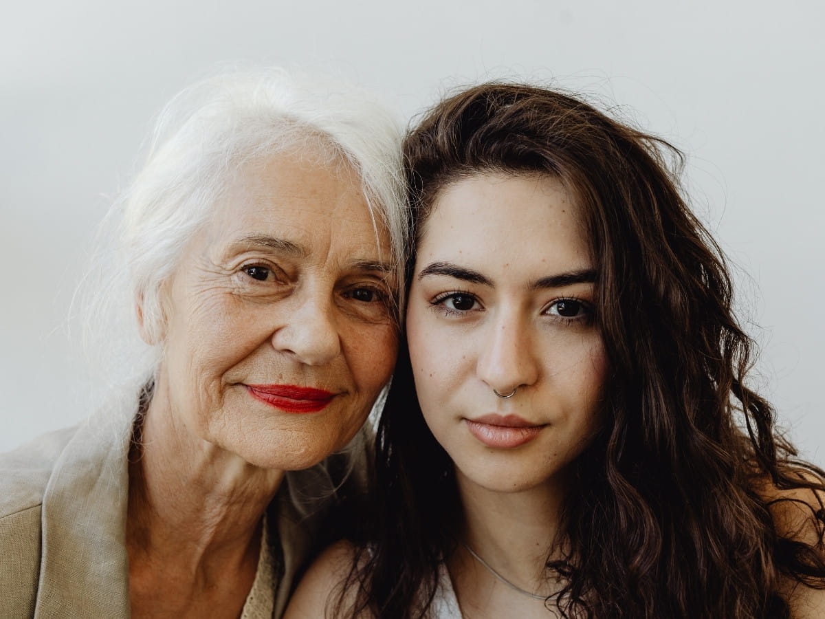 Older and younger woman together representing healthy skin and natural anti-aging across generations.