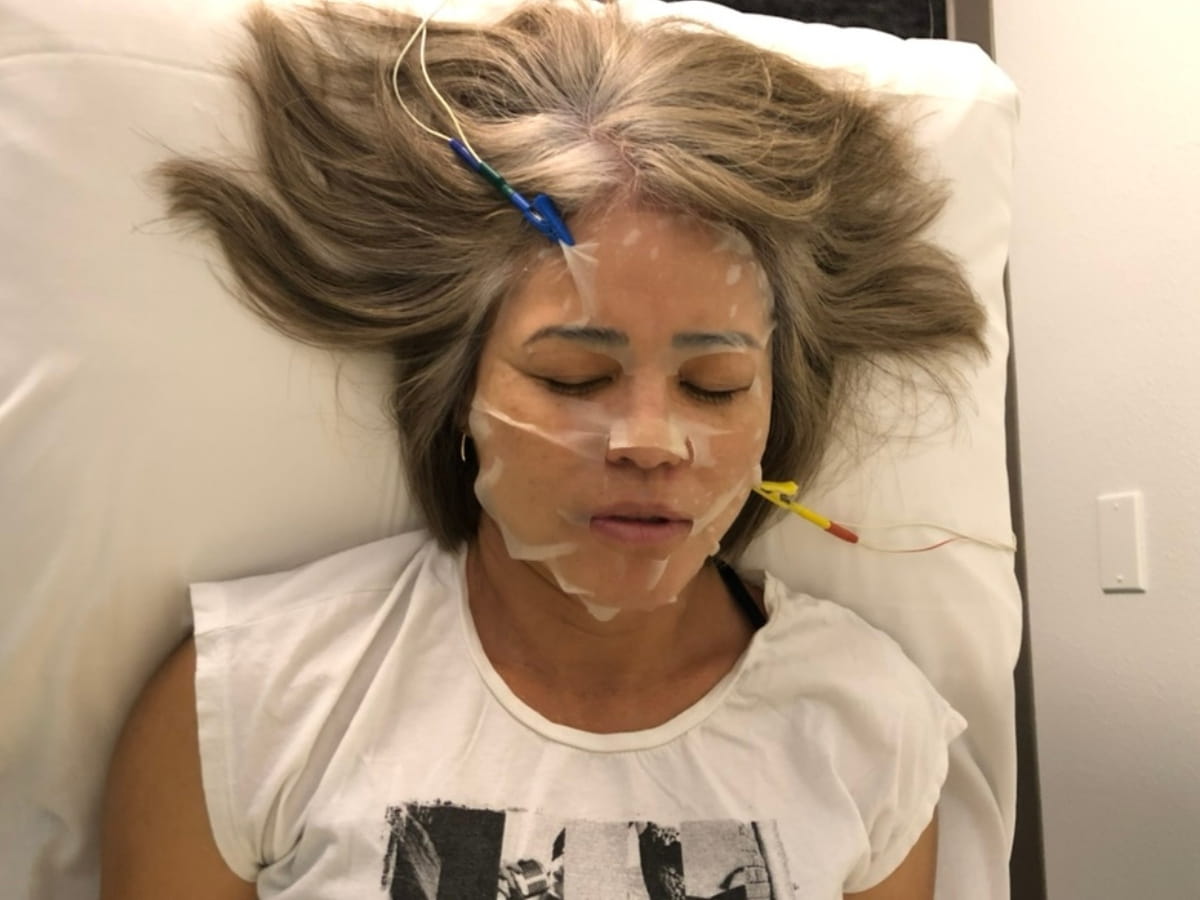 A real patient at Lim Acupuncture Clinic having a Frequency Specific Microcurrent facial mask treatment is used as part of natural anti-aging therapies to support skin repair and regeneration.