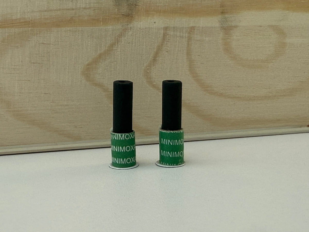 Two moxibustion sticks displayed on a treatment table.